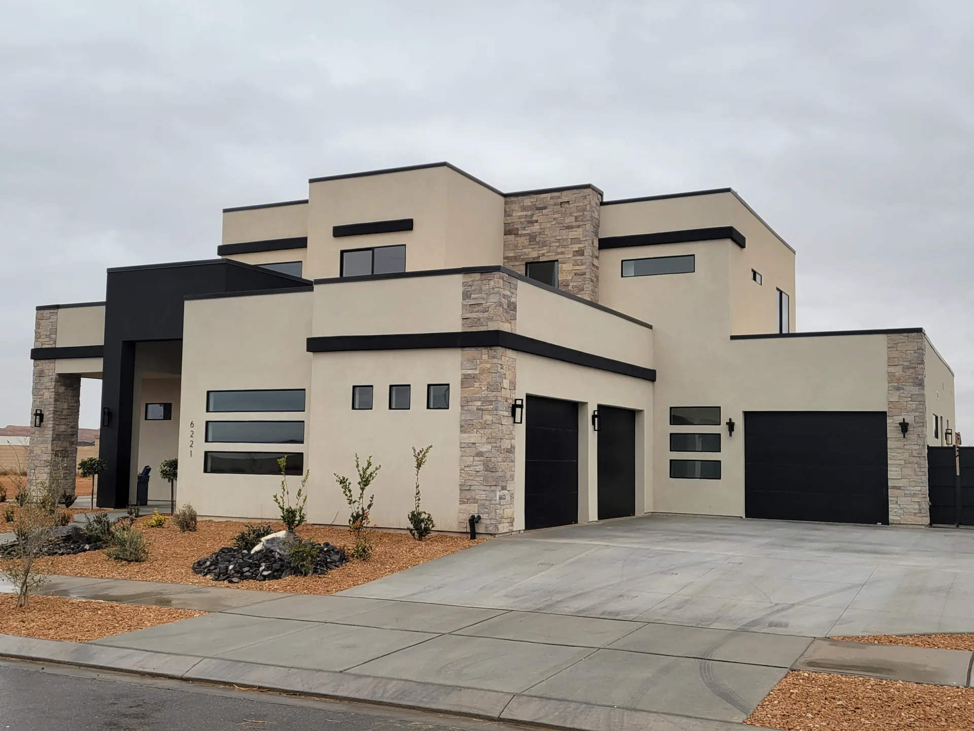 Contemporary home with stepped parapets and a stone entrance